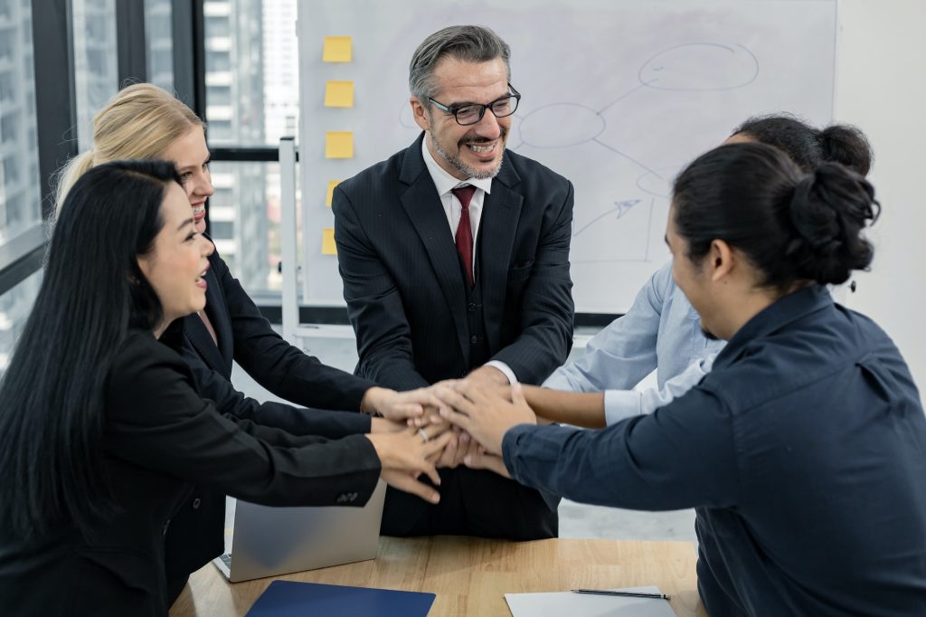 Business team showing unity with their hands together.