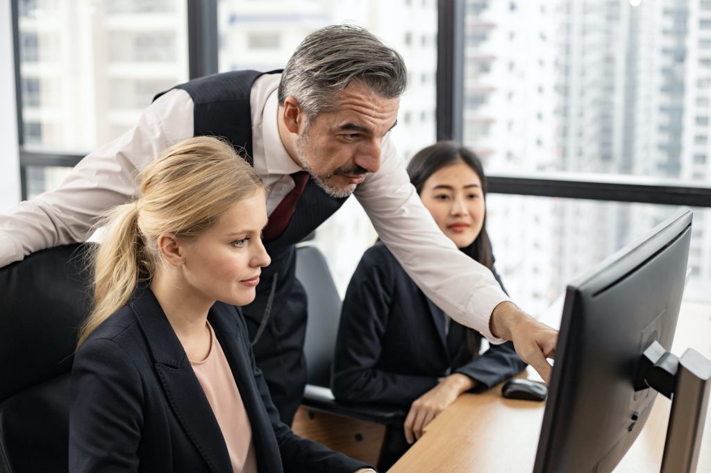 Male supervisor teaches the employees in the company.